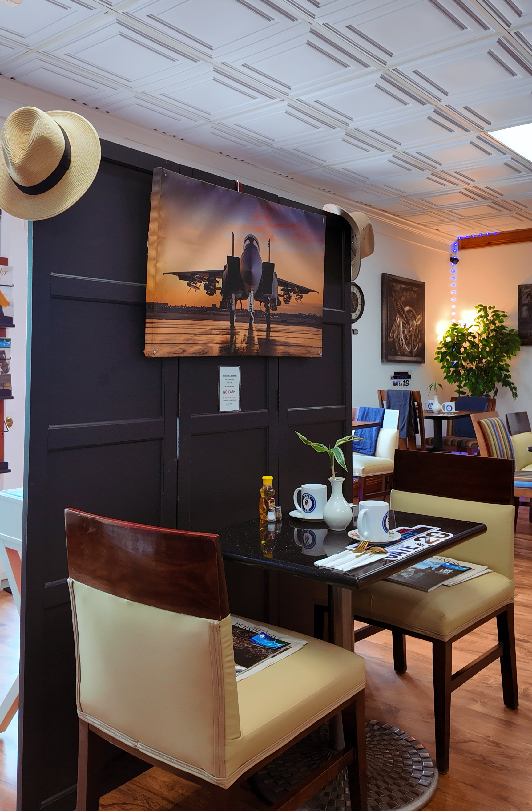 Jet Cafe interior with fighter jet poster and cozy dining setup