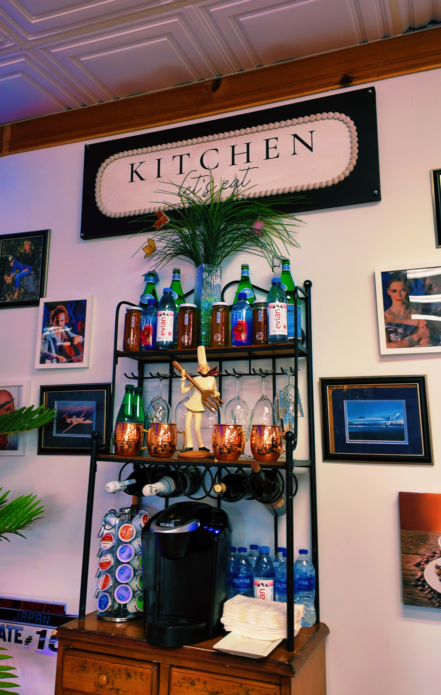 Kitchen area with beverage station, Fiji and Perrier water bottles, and copper Moscow mule mugs